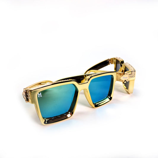 Gold-framed sunglasses with blue lenses on a white background