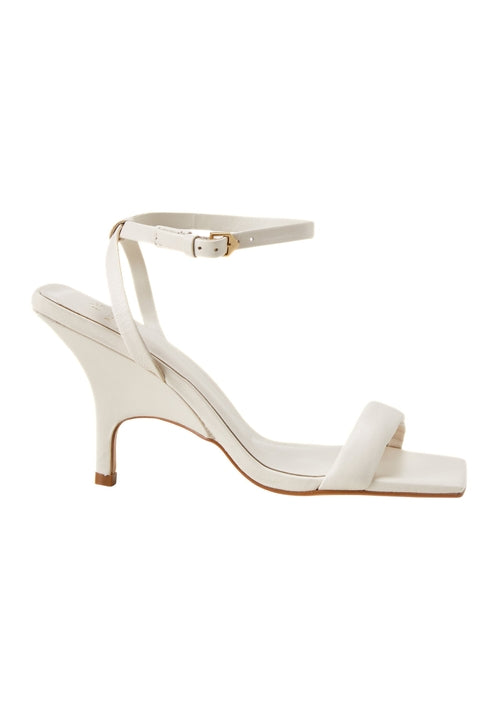 White high-heeled sandal with thin strap on a white background