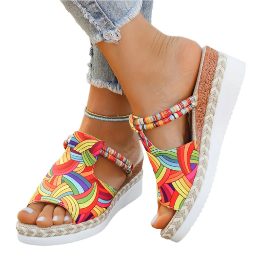 Colorful wedge sandals with espadrille sole on a white background