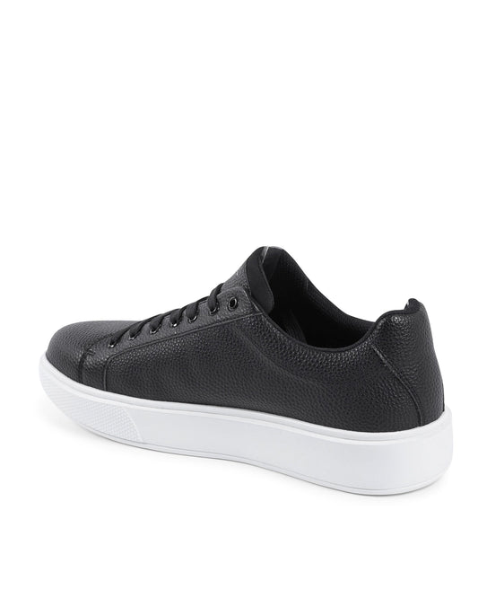 Black sneaker with white sole on a white background