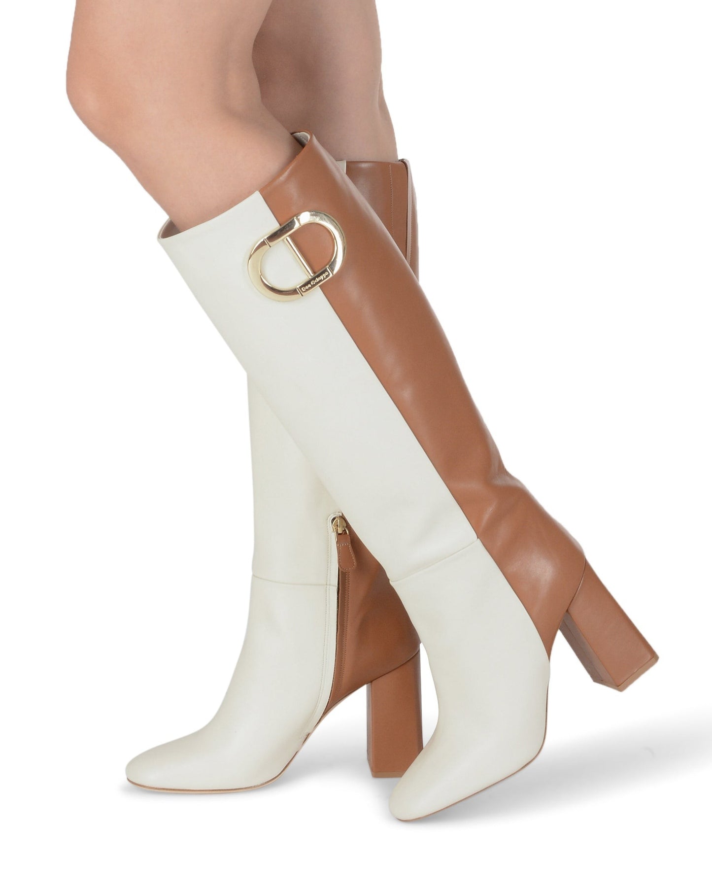 White and brown knee-high boots with gold buckles on a white background