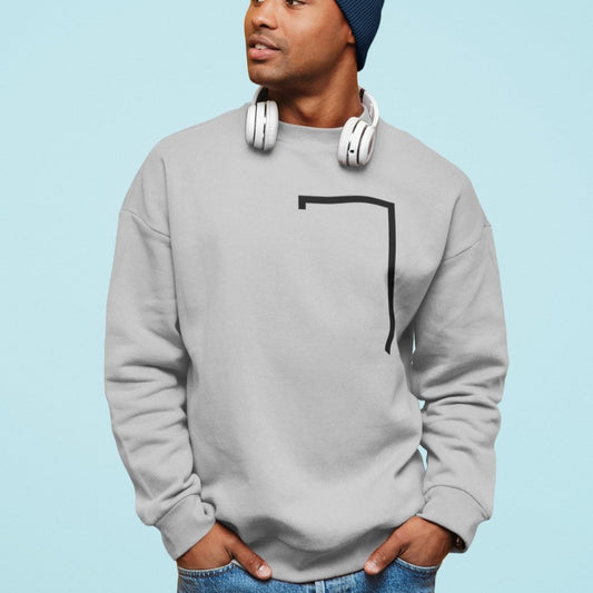 Person wearing a gray sweatshirt with a black design on a light blue background