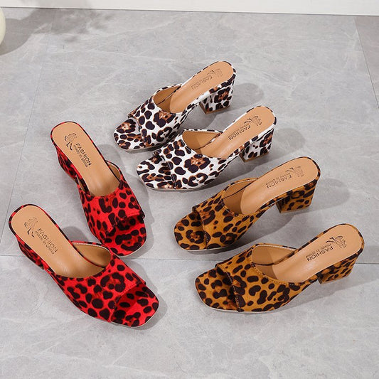 Set of leopard print shoes on a gray surface