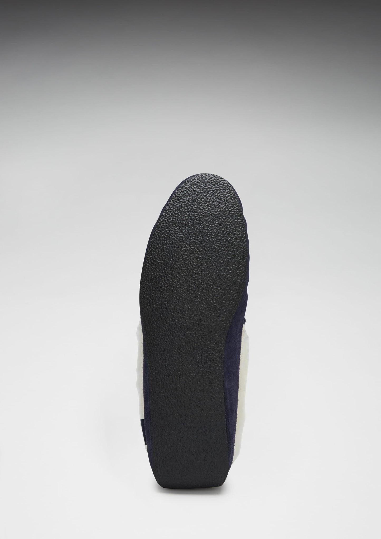 Black sole of a shoe on a light gray background