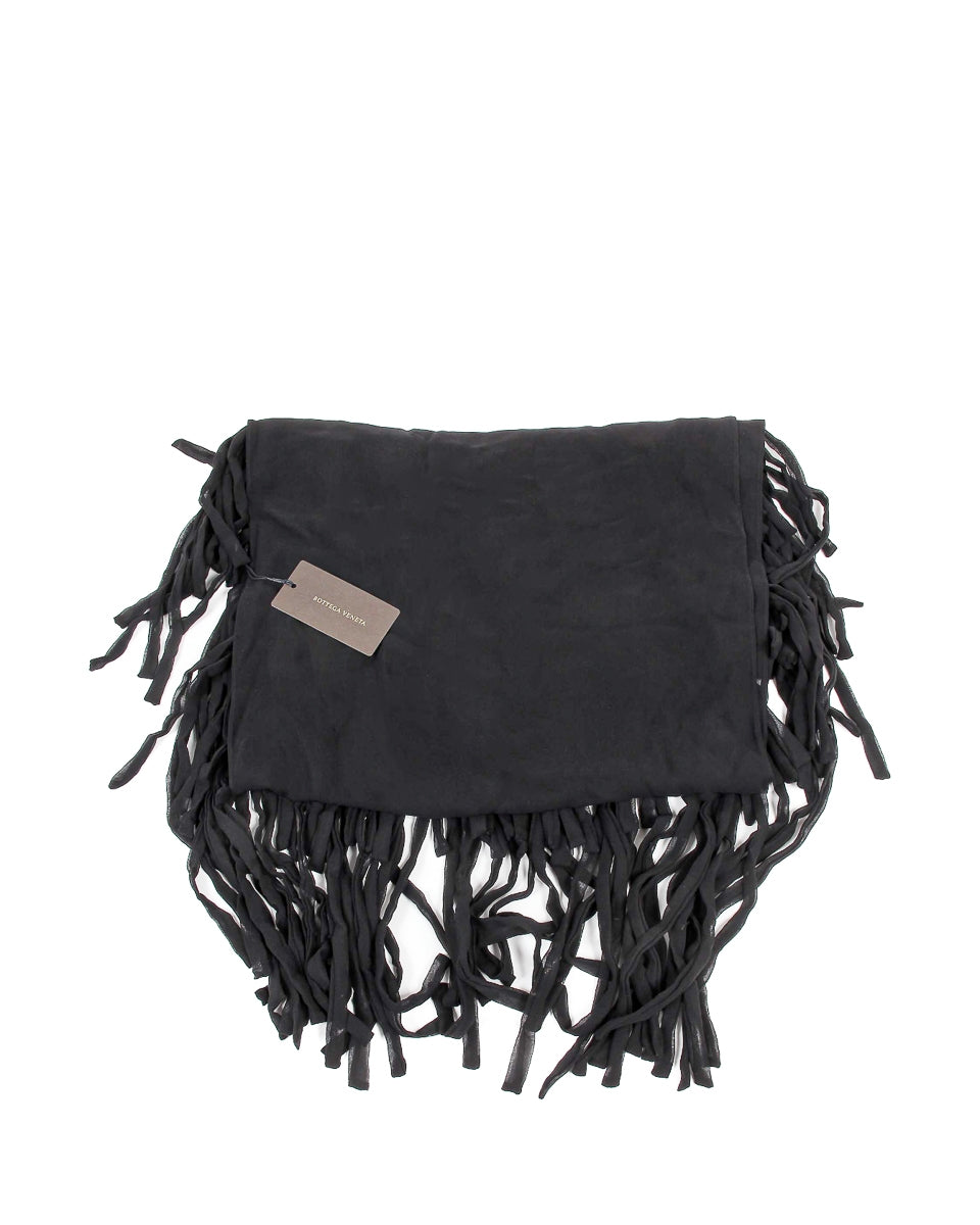 Black fringe bag with a beige tag on a white background