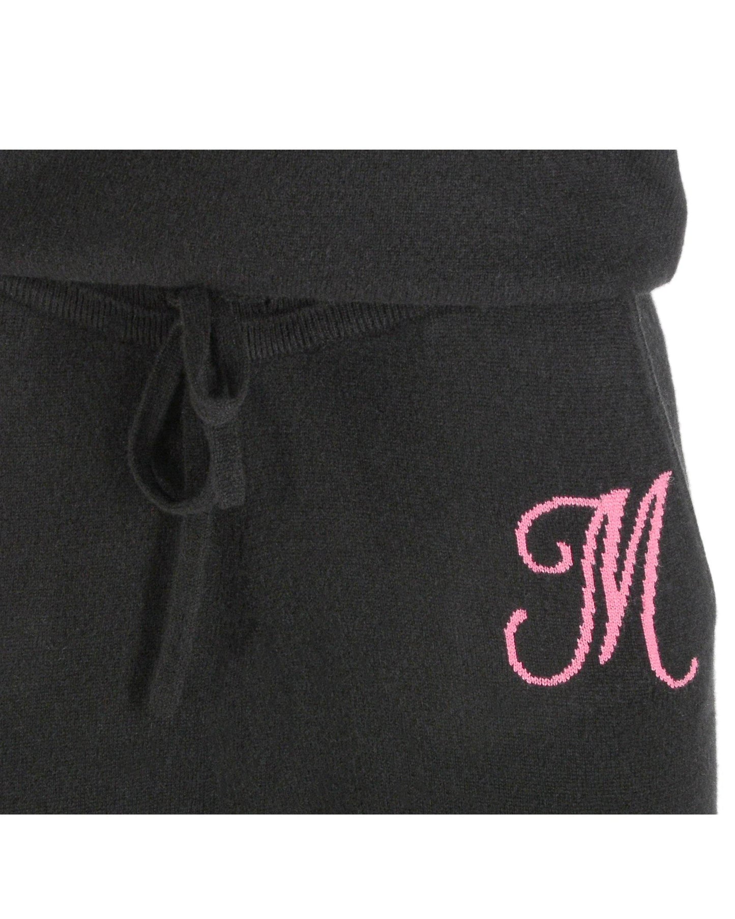 Black sweatpants with a pink embroidered letter 'M' on a white background