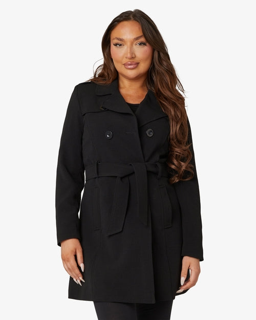 Woman wearing black coat on white background