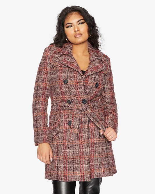 Woman wearing a plaid coat on a white background