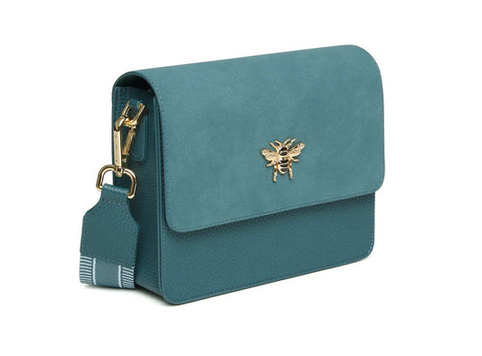 Teal handbag with a gold bee emblem on a white background