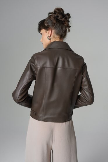 Person wearing a brown leather jacket on a gray background
