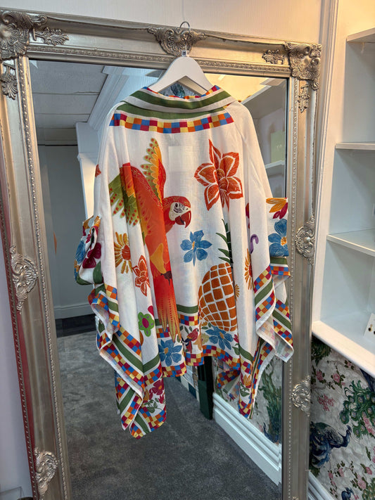 Colorful patterned sweater hanging on a mirror with decorative frame