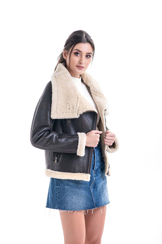 Woman wearing a brown leather jacket with white fur trim on a white background