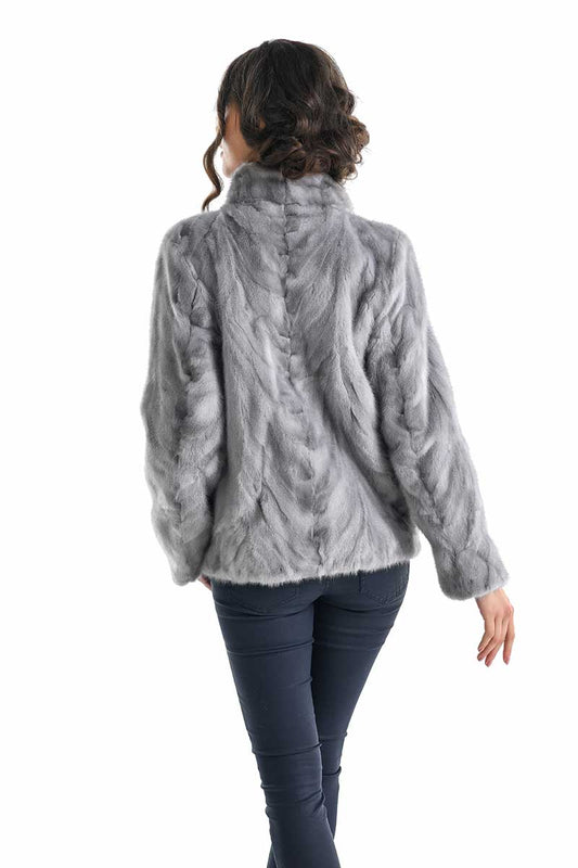 Person wearing a gray fur jacket on a white background