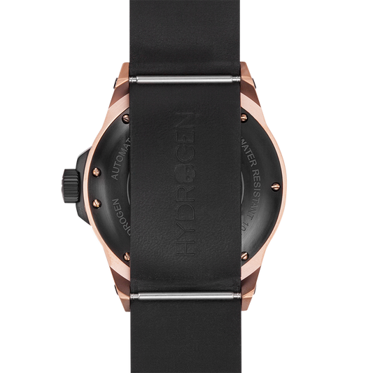 Close-up of a watch with black strap and rose gold case on a white background