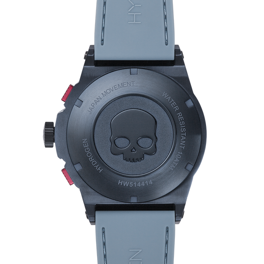 Wristwatch with skull design on the back, gray strap, and visible brand name.