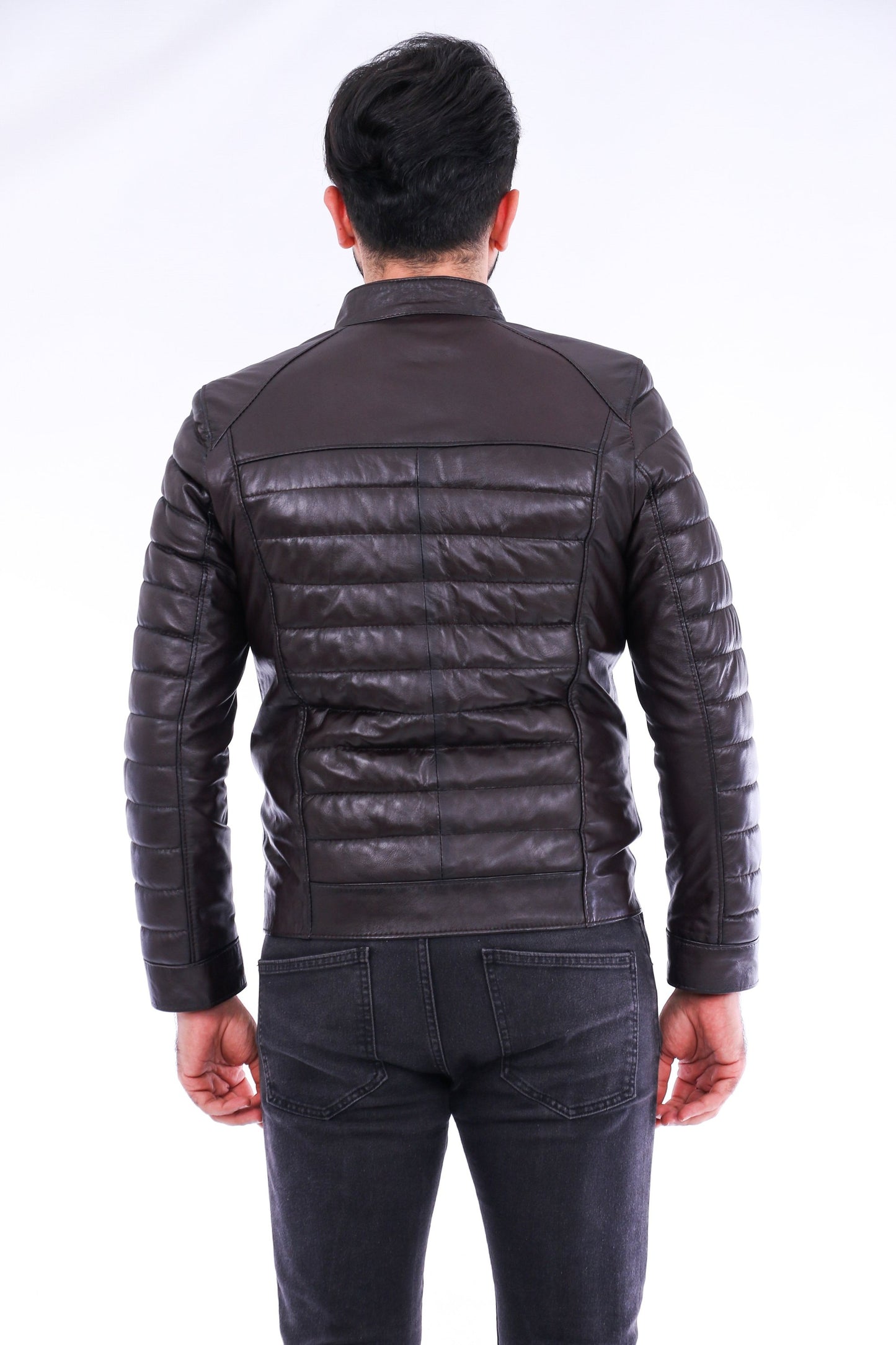 Person wearing a black leather jacket from behind on a white background