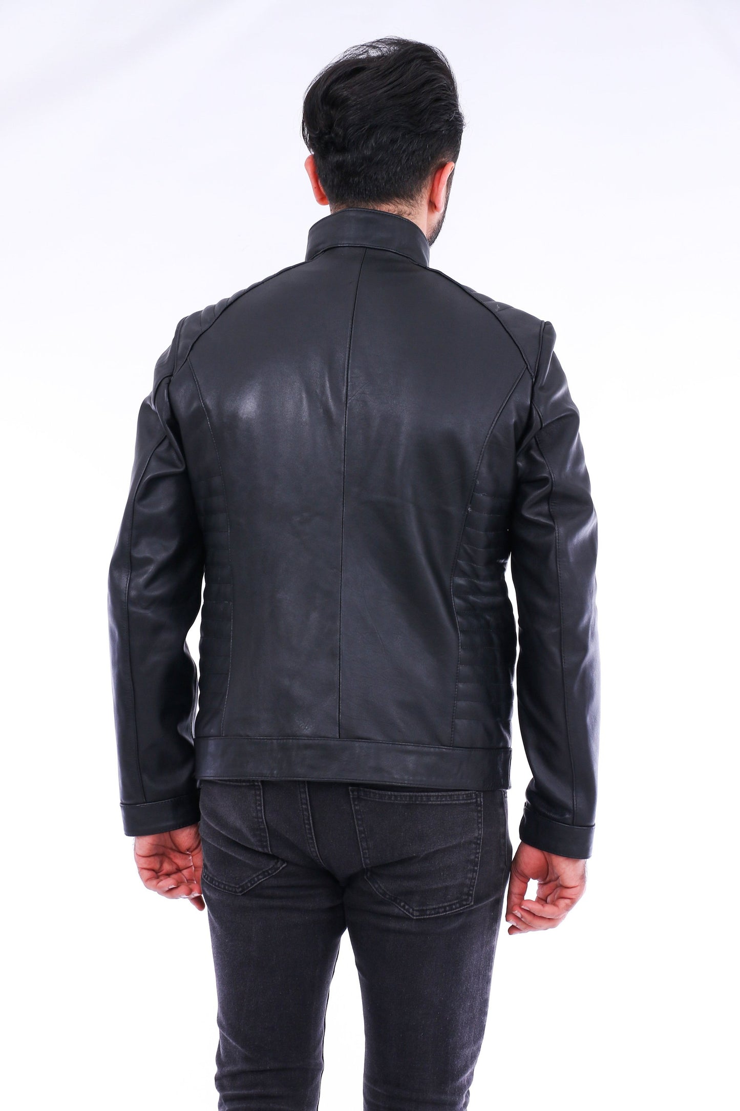 Person wearing a black leather jacket on a white background