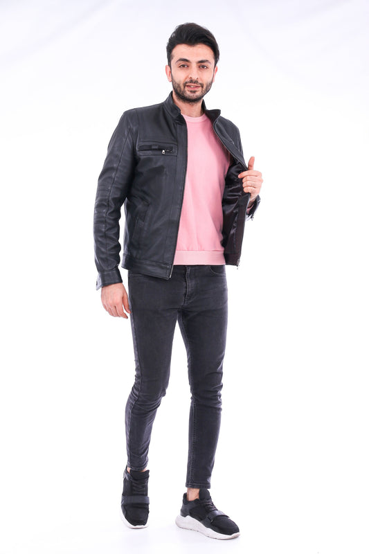 Man wearing a black jacket, pink shirt, and black jeans on a white background