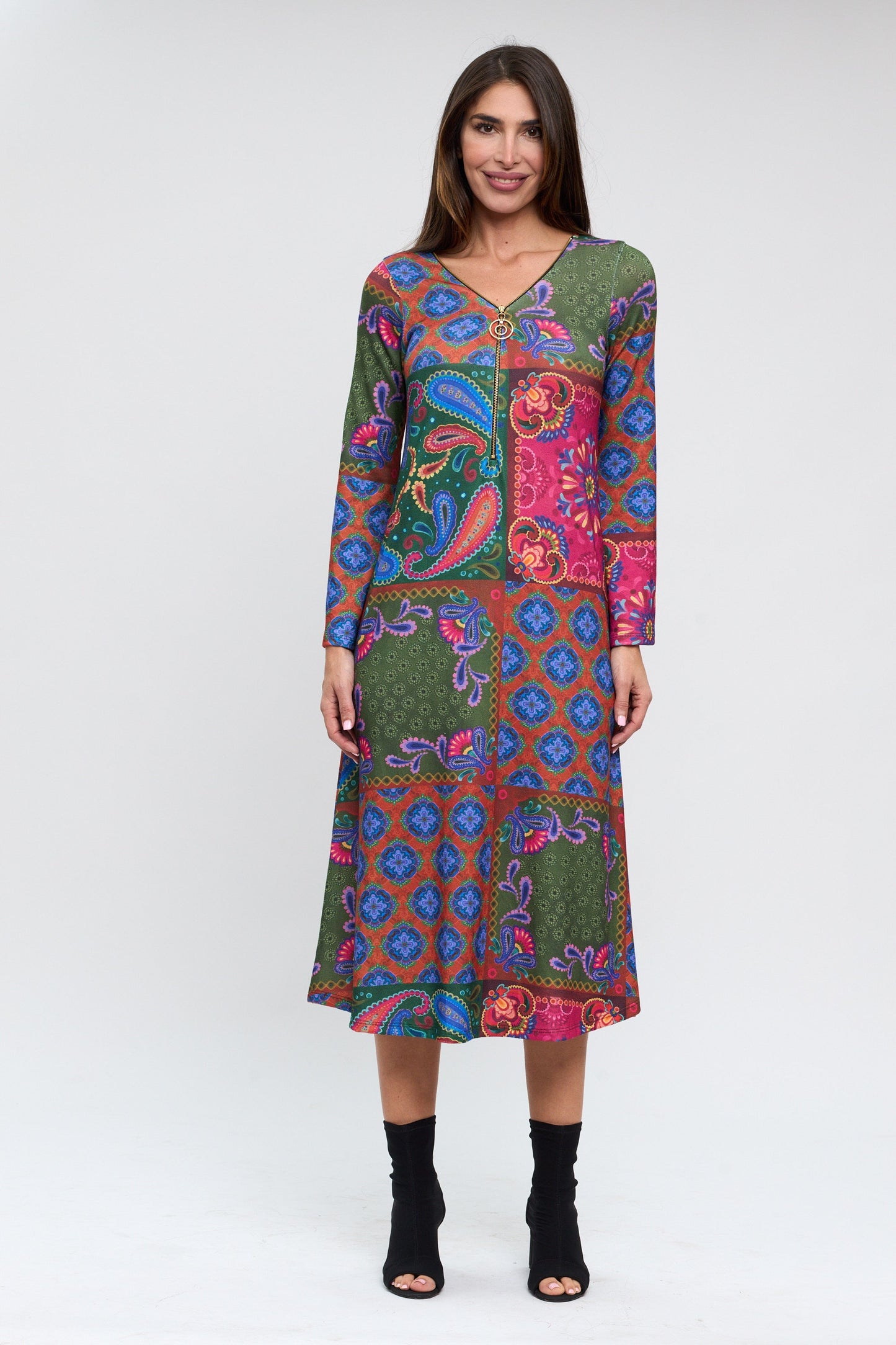 Woman wearing a colorful patterned dress on a white background