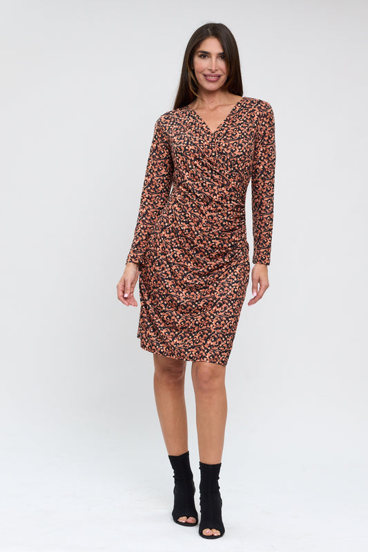 Woman wearing a patterned dress on a white background