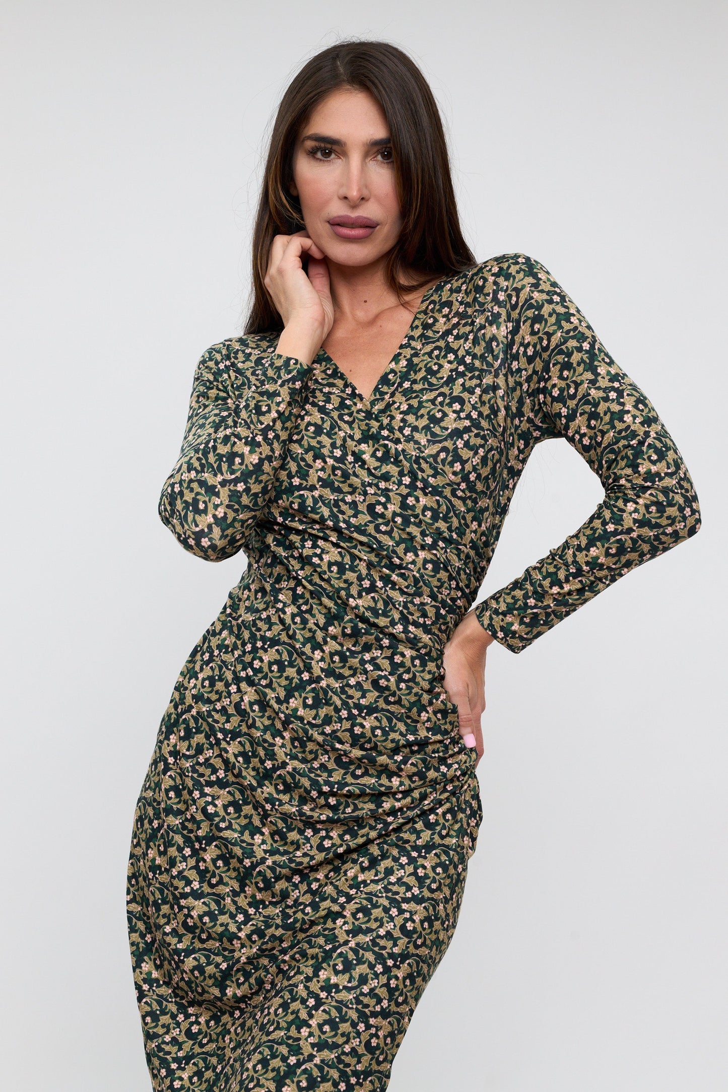 Woman wearing a floral dress against a white background