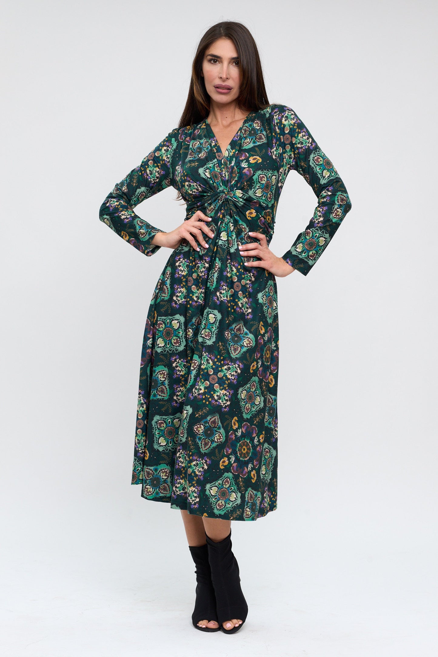 Woman wearing a green floral dress on a white background