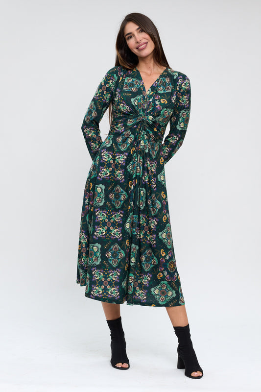 Woman wearing a green floral dress on a white background