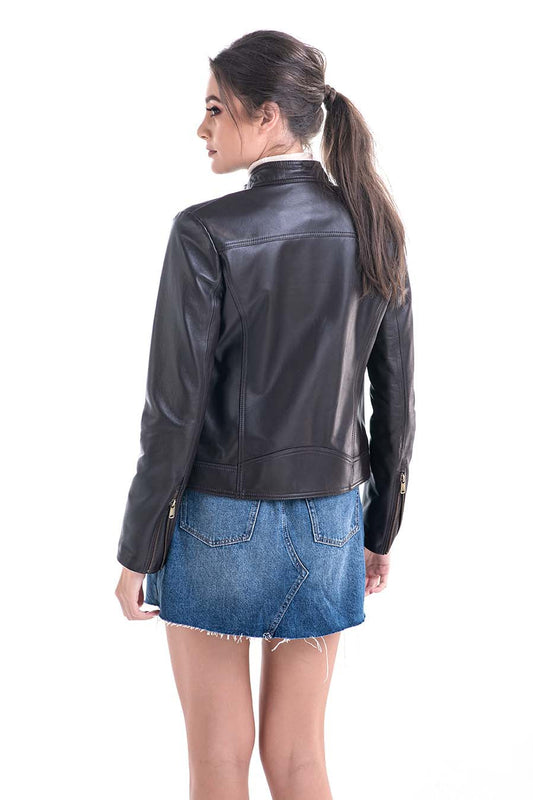 Woman wearing a brown leather jacket and blue denim skirt on a white background