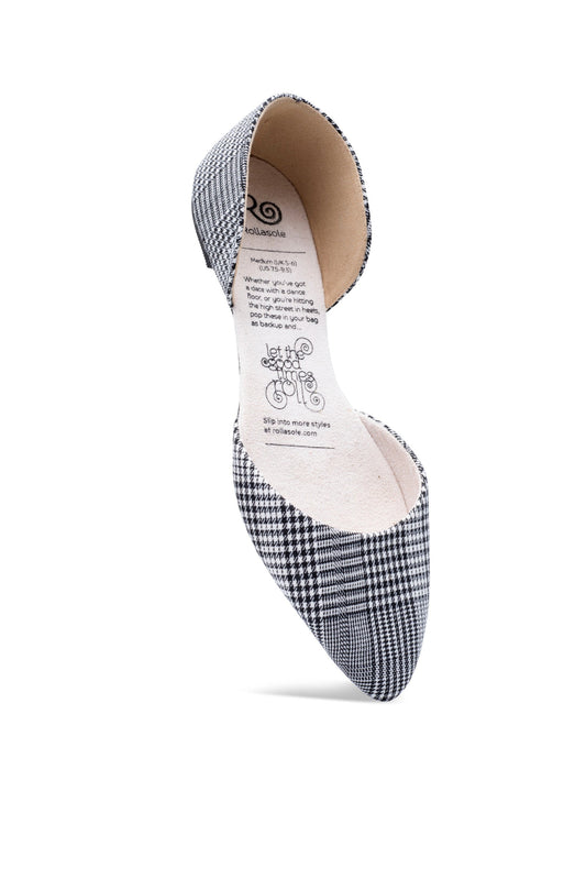 Black and white checkered shoe with a visible brand label on a white background