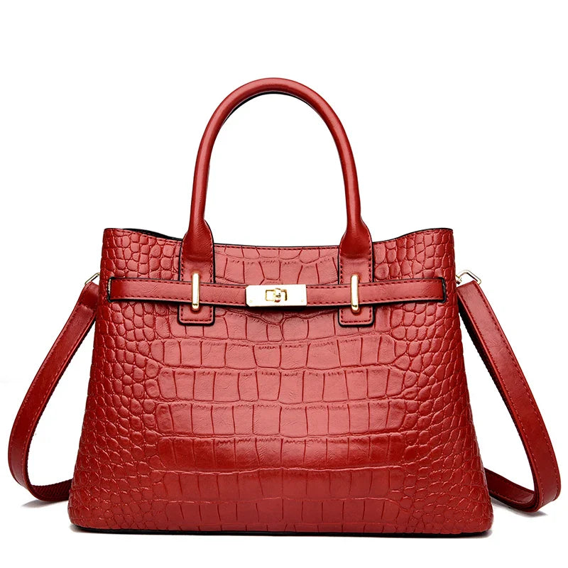 Red crocodile-patterned handbag on a white background