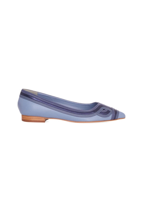 Blue flat shoe with a brown sole on a white background