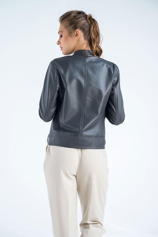 Person wearing a gray leather jacket on a white background