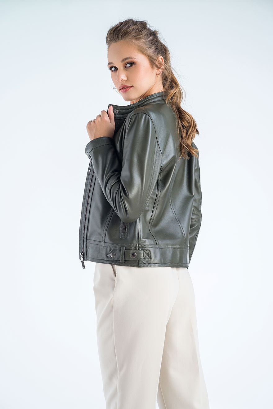 Woman wearing a green leather jacket on a white background