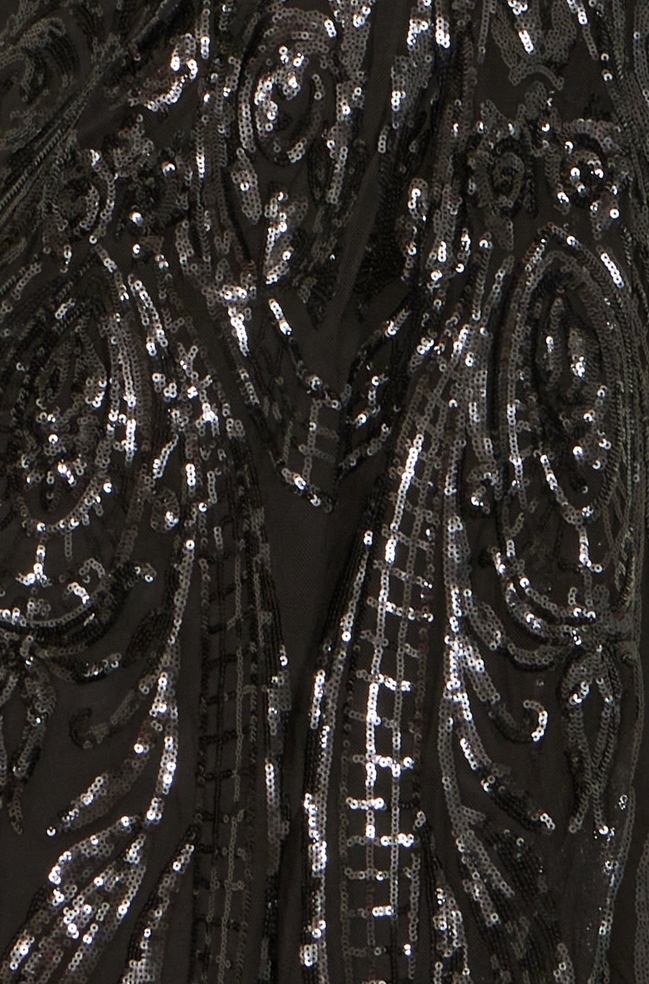 Close-up of a black garment with silver sequin patterns