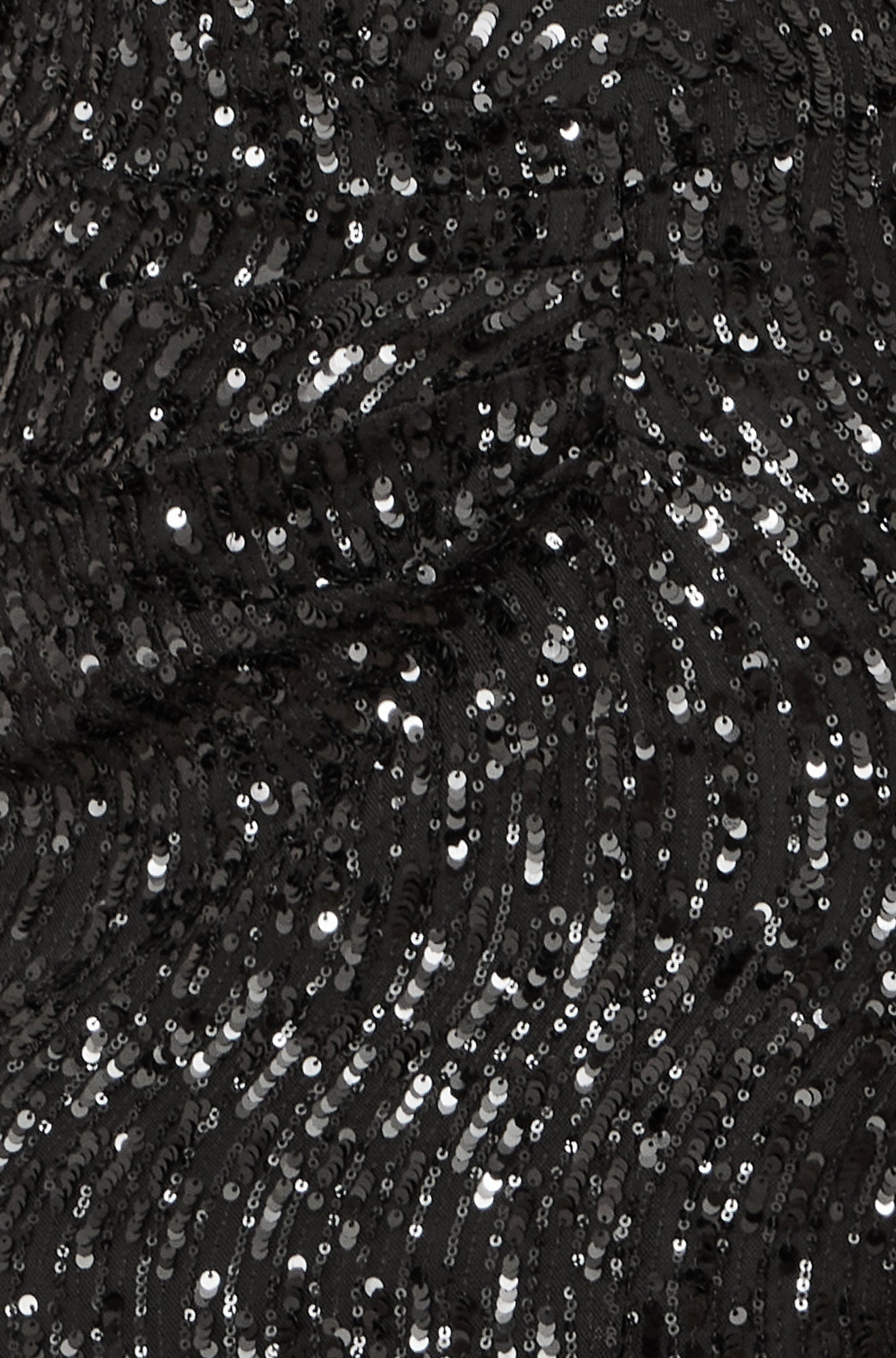 Close-up of black sequin fabric with a textured pattern