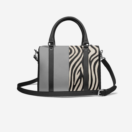 Handbag with zebra print and gray panels on a white background