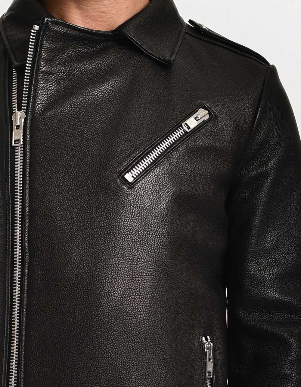 Close-up of a black leather jacket with zippers on a white background