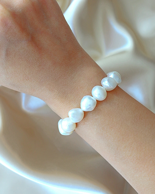 Pearl bracelet on a wrist with a soft background