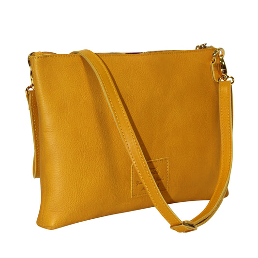 Yellow leather crossbody bag on a white background