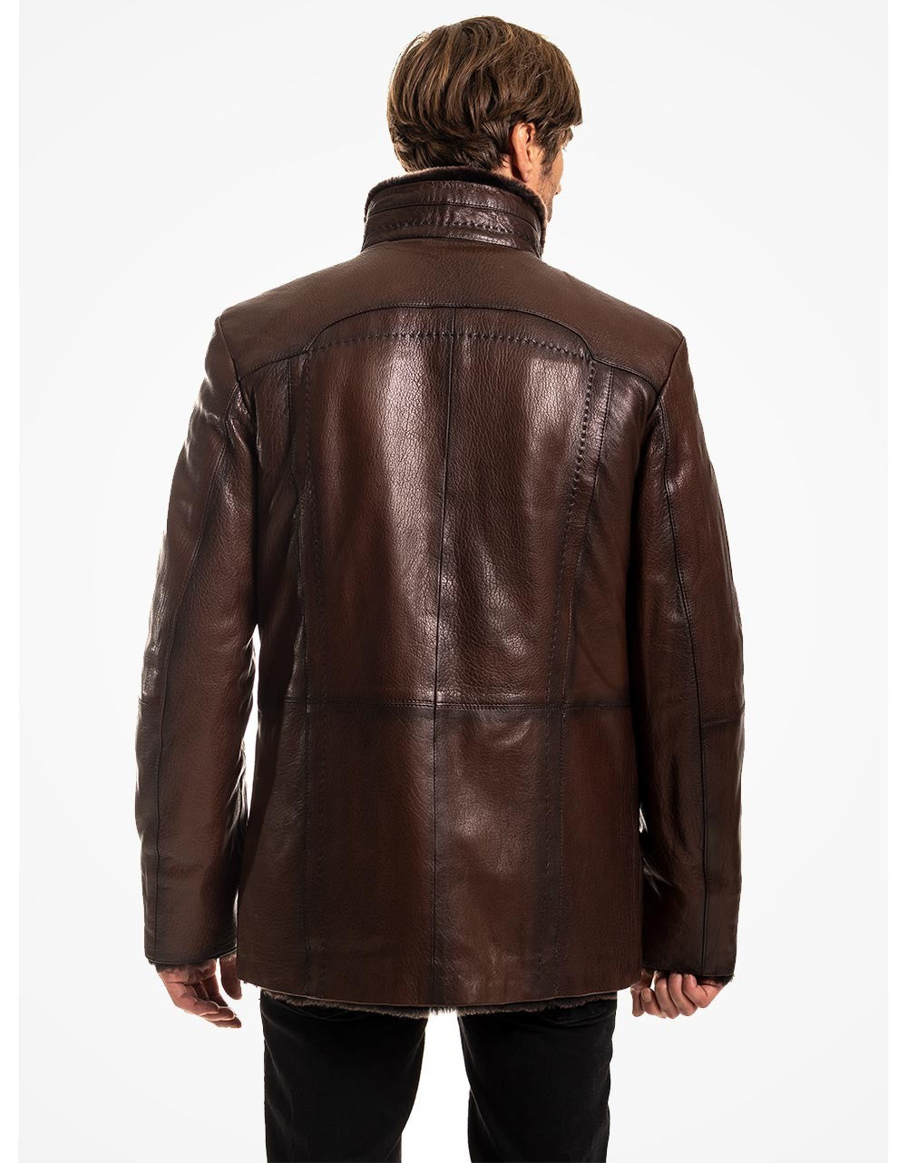 Brown leather jacket worn by a person on a white background