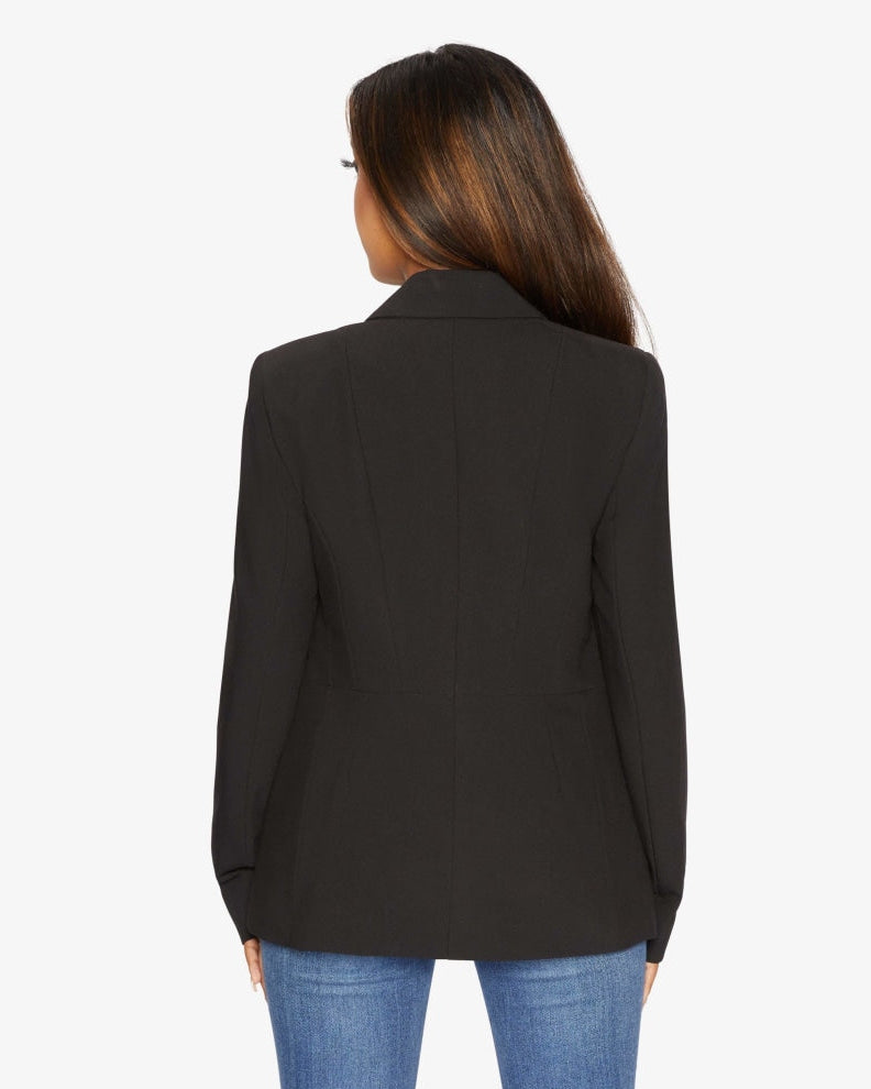 Person wearing a black blazer on a white background