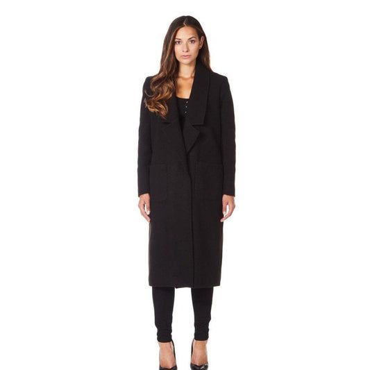 Woman wearing a black coat on a white background