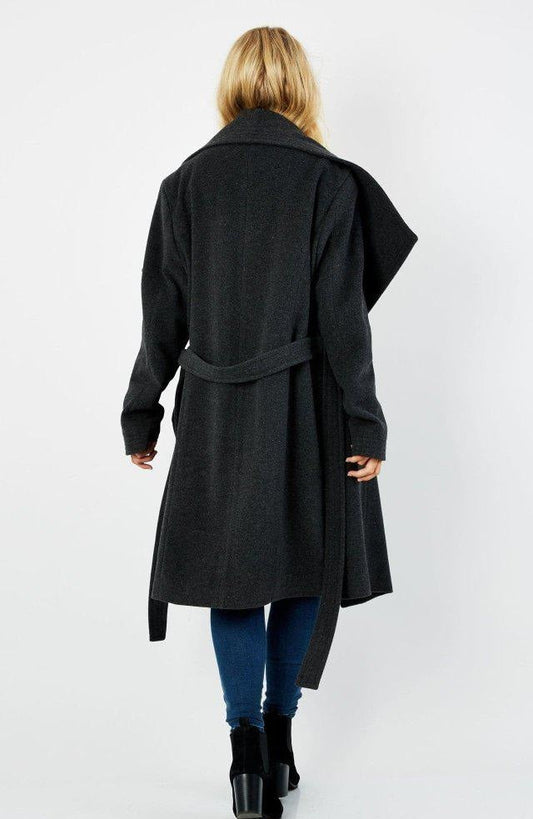 Person wearing a black coat on a white background.