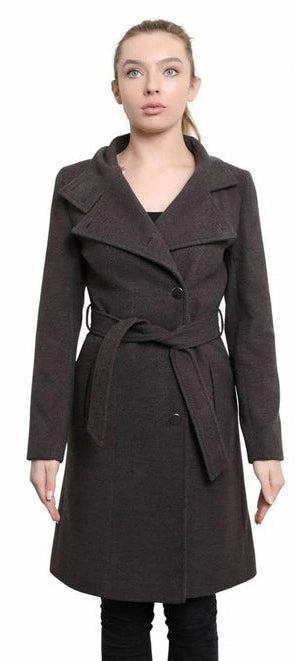 Woman wearing a dark brown coat with a belt, standing against a white background.