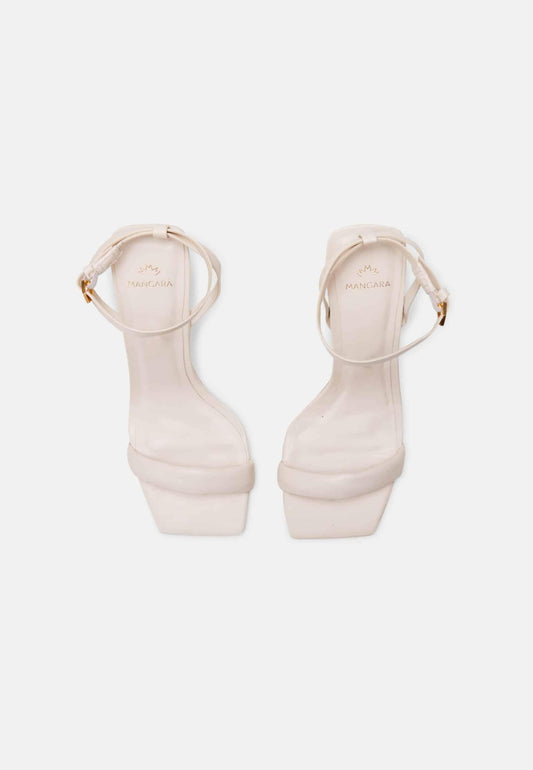 Pair of white high-heeled sandals on a white background