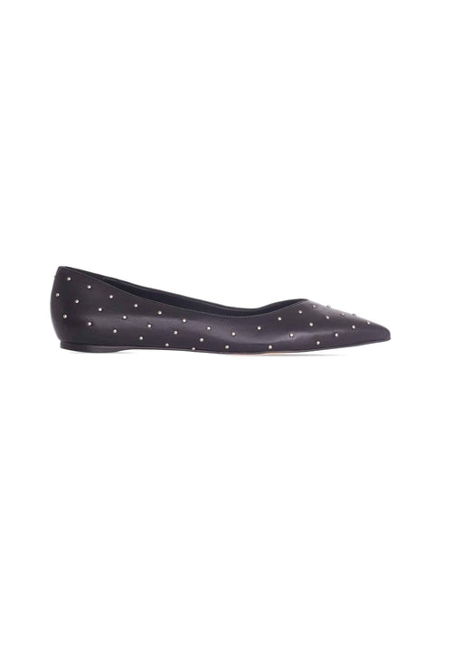 Black flat shoe with white polka dots on a white background