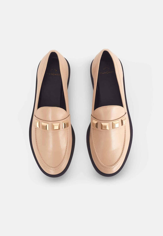 Pair of beige loafers with gold accents on a light gray background