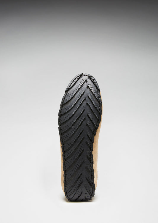 Black sole of a shoe on a gray background