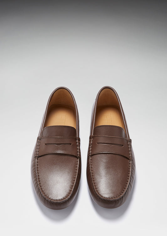 Pair of brown loafers on a light gray background