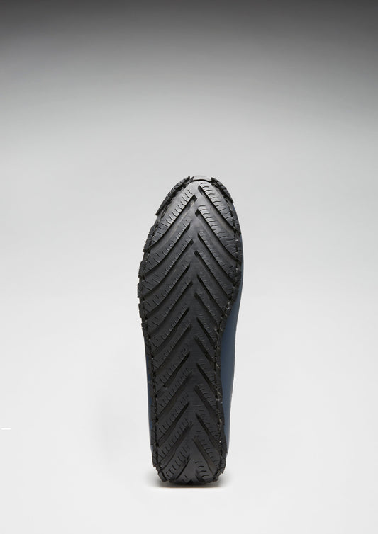 Close-up of a black rubber sole on a white background